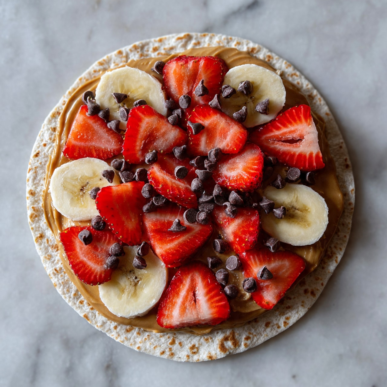Two white square plates are placed side by side on a wooden board over a white marbled texture. Each plate holds two folded tortillas forming two layers with a toasted light brown color and some darker spots. The left plate's tortillas have a visible layer of sliced strawberries peeking out along with a reddish filling. The right plate's tortillas show a dark chocolate-like filling inside. Each plate is garnished with a whole red strawberry and a couple of round banana slices, positioned on the upper left corner of the left plate and the upper right corner of the right plate. Photo taken with an iphone --ar 4:5 --v 7