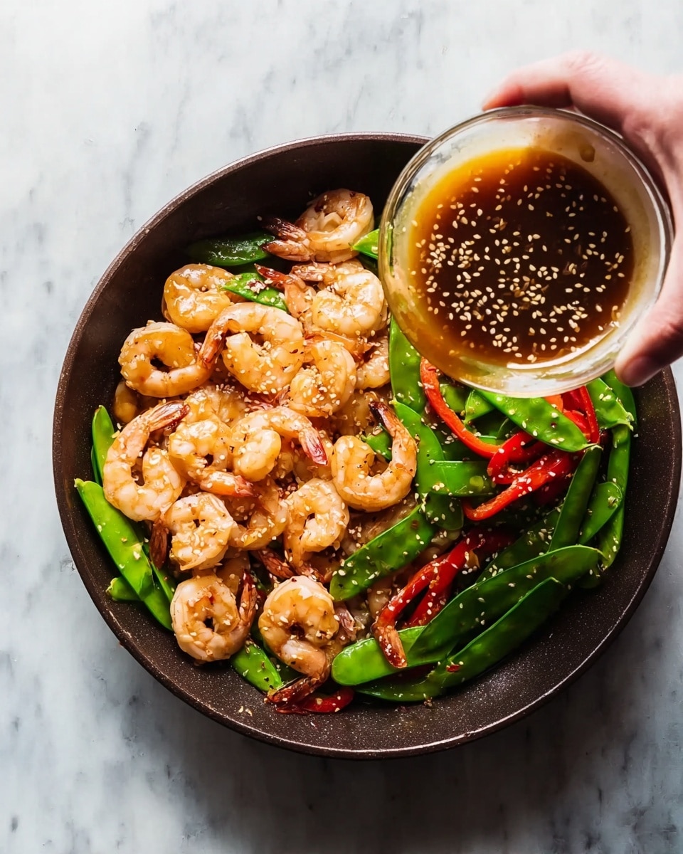 A white plate holds a bed of fluffy white rice as the bottom layer, topped with a colorful mix of cooked shrimp, bright red bell pepper strips, green asparagus pieces, and snap peas in the second layer. The shrimp are pinkish-orange and glossy, coated with a shiny brown sauce that glistens in the light. The vegetables show vibrant red and green colors, with a slightly soft texture from cooking. Small bits of chopped green herbs are sprinkled on top, adding a fresh touch. The entire dish sits on a white marbled surface photo taken with an iphone --ar 4:5 --v 7