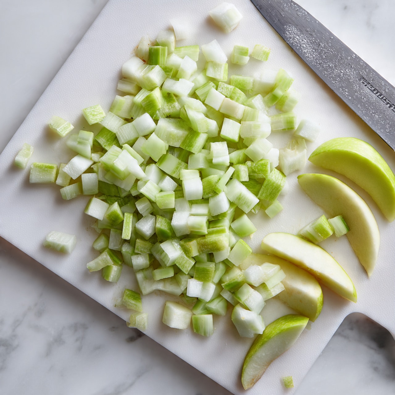 The image shows a white oval dish filled with a warm dessert with two main layers visible: a golden brown crumbly oat topping that looks crunchy with small clusters, and beneath it a soft, light golden cooked fruit layer. On top of the oat layer, there are two round scoops of white ice cream starting to melt slightly, creating a creamy pool around the edges. A spoon in the front right corner scoops some of the dessert, revealing the soft fruit beneath and chunks of the oat topping. The dish sits on a white marbled surface. photo taken with an iphone --ar 4:5 --v 7