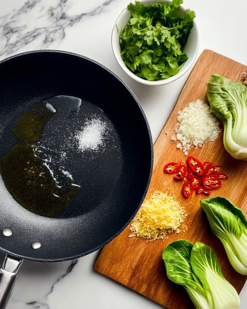 A blue bowl filled with a clear soup showing three pale dumplings on the left side above some yellow curly noodles. On the right side, there's a large bright green bok choy leaf with a shiny, smooth texture. In the middle, thin slices of red chili lay on top of the noodles, with sliced light green scallions just below them. Fresh, vibrant green cilantro leaves sit at the bottom right corner of the bowl. Light wooden chopsticks rest on the edge of the bowl. The bowl is placed on a white marbled surface. Photo taken with an iphone --ar 4:5 --v 7