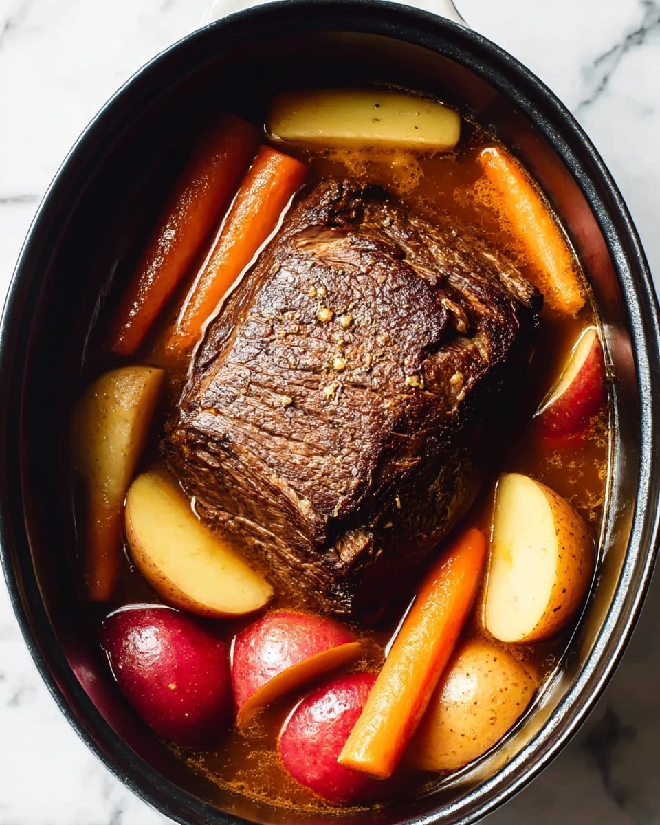 A round white ceramic plate holds a serving of mashed potatoes on the left side, creamy and smooth with a soft texture and pale yellow color. On the right side, there are three large pieces of dark brown braised beef, tender and slightly shredded, surrounded by orange carrot chunks and whole small potatoes with light brown and red skins. The dish is coated with a rich brown gravy that pools around the meat and vegetables. The plate is placed on a white marbled surface photo taken with an iphone --ar 4:5 --v 7