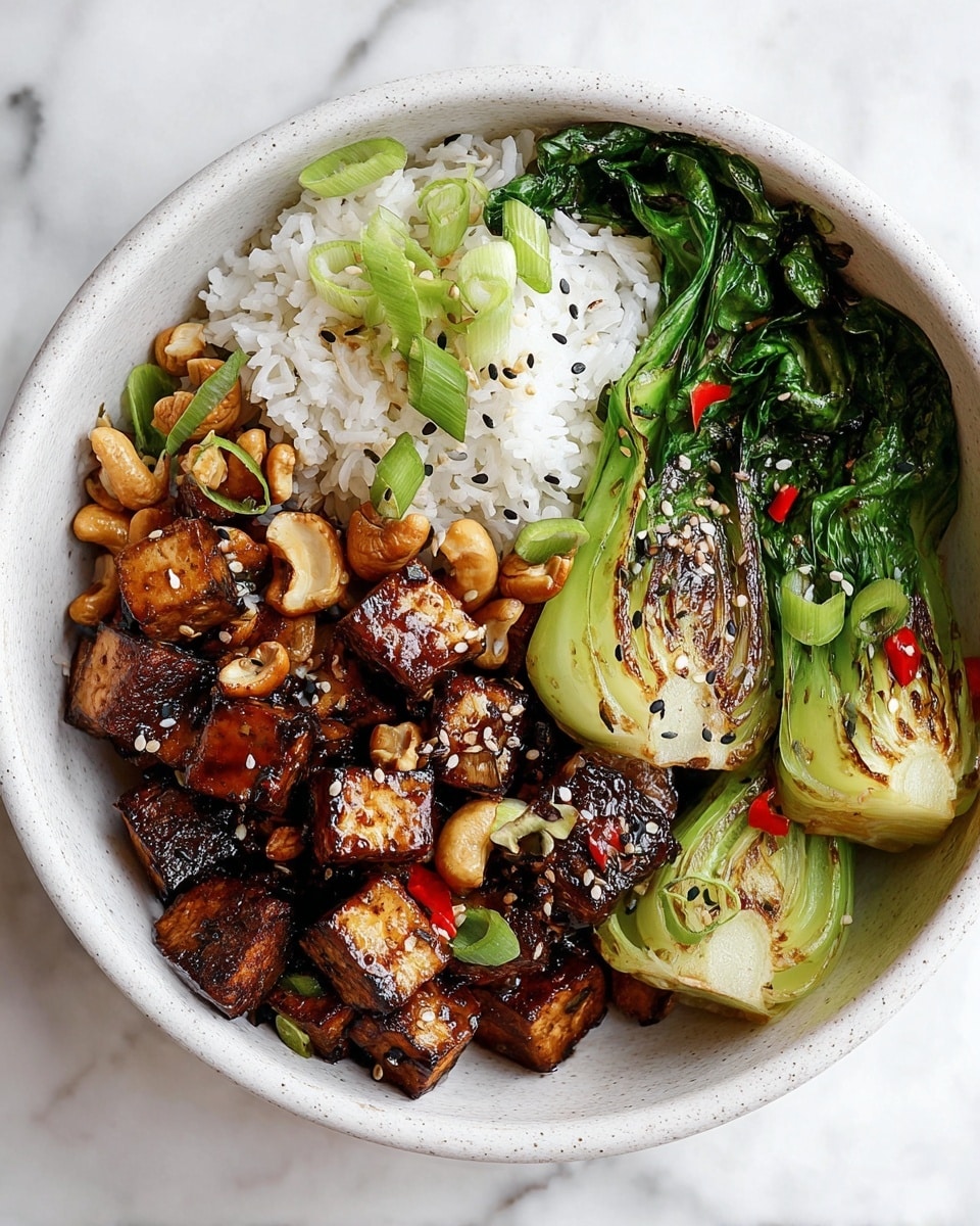 A white bowl on a white marbled surface holds a three-part meal. On the left, there is a layer of fluffy white rice topped with a few green onion slices and scattered sesame seeds. The center part has dark brown, caramelized tofu cubes mixed with a few whole cashews and small red chili pieces, all sprinkled with white and black sesame seeds. On the right side, there are bright green cooked bok choy leaves with some browned edges placed over the rice, adding a fresh look. The textures show a mix of soft rice, crispy tofu, crunchy cashews, and tender greens. Photo taken with an iphone --ar 4:5 --v 7