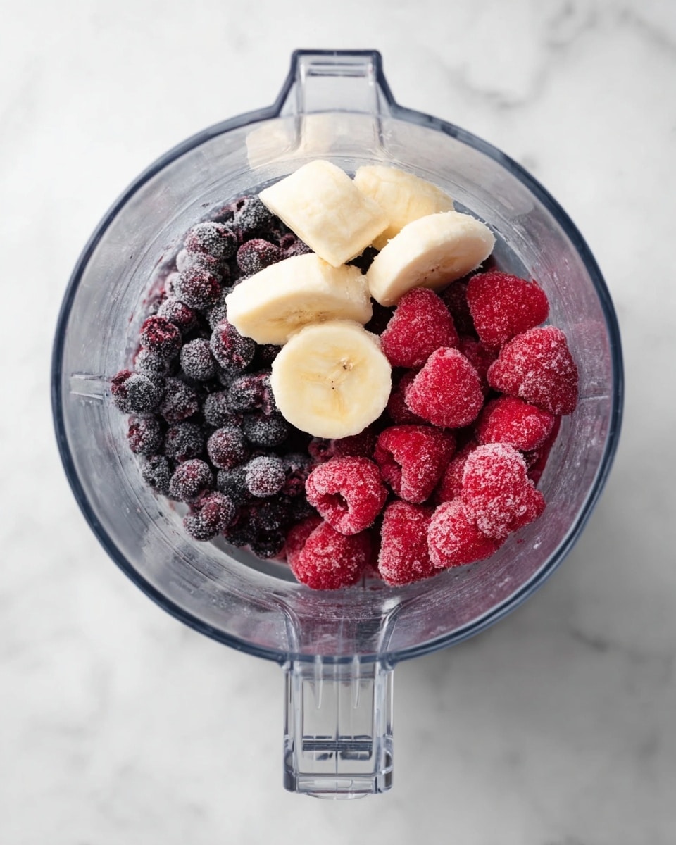 A white bowl filled with a smooth purple smoothie that has a swirl pattern in the center; the top edge is decorated with a strip of white coconut flakes and crunchy granola on one side, a dollop of light brown nut butter on the left, a line of red raspberries at the bottom, a small cluster of dark blueberries on the right, and two halves of red strawberries with green leaves on the upper right side. Surrounding the bowl on a white marbled textured board are three small white bowls, one filled with bright red strawberries and raspberries, one filled with dark blue blueberries, and the last one with a swirl of creamy light brown nut butter. Scattered around are a few loose raspberries and blueberries. Photo taken with an iphone --ar 4:5 --v 7