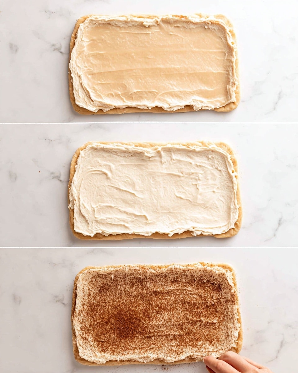 The image shows three stages of preparing a dough rectangle with layers on a white marbled surface. The top layer is simply a smooth, light beige dough rectangle with rounded edges. The middle layer shows the same dough rectangle with a creamy, pale spread evenly covered over it, creating a slightly textured, soft off-white surface. The bottom layer has an even layer of a brown cinnamon sugar mixture sprinkled densely over the creamy spread, making the dough surface look grainy and speckled with dark brown and reddish tones. A woman's hand is gently touching the corner of the dough in the bottom image, hinting at the next step. photo taken with an iphone --ar 4:5 --v 7