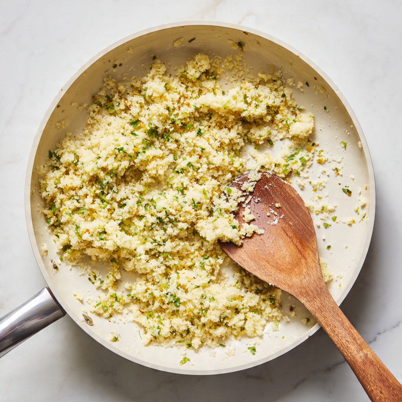 A white plate on a white marbled surface holds a piece of fish with a light golden, crumbly crust mixed with green herbs, topped with a thin, round slice of lemon. Next to the fish is a mound of plain white rice with soft texture, and a small green leaf garnish sits at the edge of the plate. In the background, another white plate with a similar fish and lemon slice is slightly blurred. Photo taken with an iphone --ar 4:5 --v 7