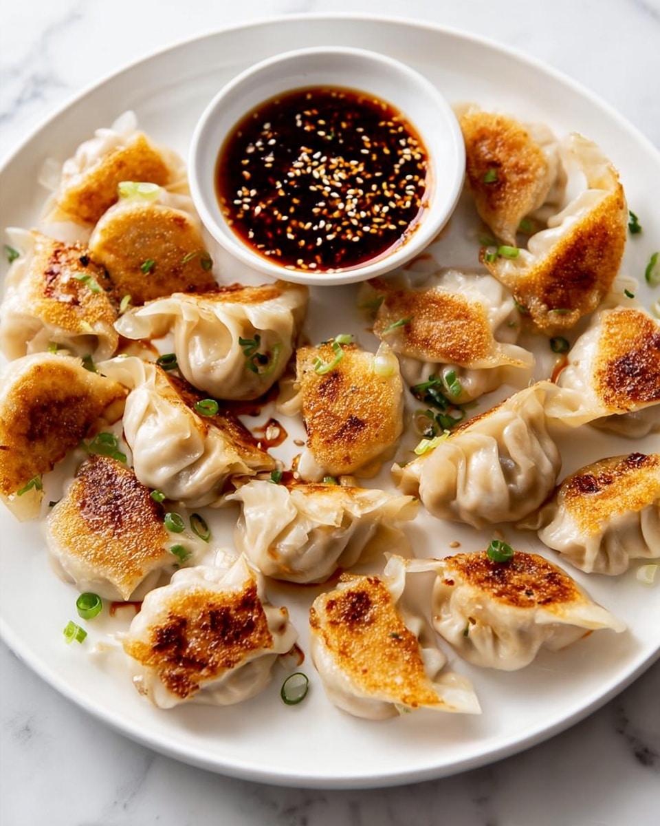 The image shows a white plate with a circle of pan-fried dumplings, each dumpling having a light beige, soft dough with pleated edges and golden brown crispy bottoms. Small green onion pieces are sprinkled over the dumplings, adding bright green spots. In the center of the plate, a small white bowl holds a dark red-brown sauce topped with white sesame seeds. The plate sits on a white marbled surface with a light cloth in the background. photo taken with an iphone --ar 4:5 --v 7