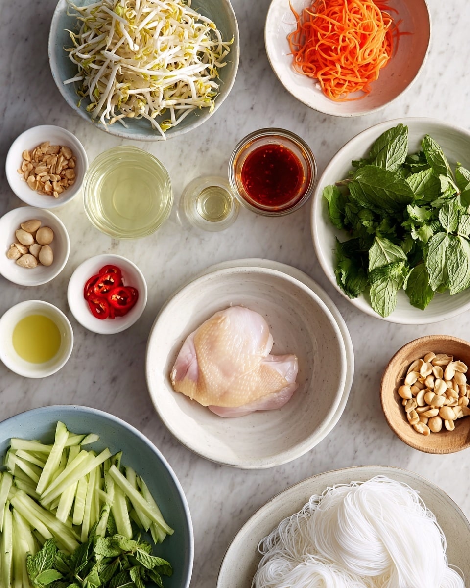 The image shows many small bowls arranged on a white marbled surface, each with different fresh ingredients. In the center, there is a white bowl with a large piece of pale, raw chicken. Surrounding it, from top left clockwise, are a white bowl filled with bean sprouts, a white bowl with thin, orange carrot strips in a light liquid, and a white bowl holding fresh green herbs like mint and cilantro. Near these, there are two small glass containers, one with a pale yellow liquid, the other with a red chili sauce. In the lower right area, a white bowl contains light brown roasted peanuts, while next to it a large white plate has a nest of thin white rice noodles. On the left side, smaller white bowls hold thin cucumber ribbons, red pepper strips, white powder, and a wooden bowl with sliced green chili. The colors range from fresh green, pale orange, red, and light beige, all on a clean white marbled surface. Photo taken with an iphone --ar 4:5 --v 7