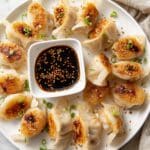 Crispy Pan-Fried Potstickers with Chili Crisp, Green Onions, and Sesame Seeds Recipe