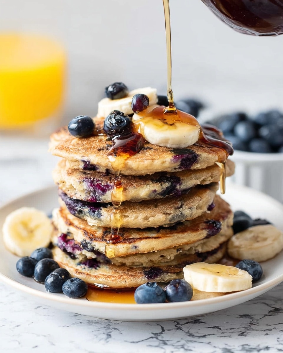 A stack of six fluffy blueberry pancakes sits on a white plate with syrup dripping down the sides and pooling at the bottom. The pancakes are light golden brown with visible blueberries baked into each layer, giving dark blue spots throughout. A small pat of butter melts on the top pancake, glistening under soft light. The plate rests on a white marbled surface next to a silver fork on the left side. In the blurred background, there is a small bowl of fresh blueberries and a light-colored pitcher, with a woman's hand visible near the top right corner holding a wooden honey dipper. photo taken with an iphone --ar 4:5 --v 7