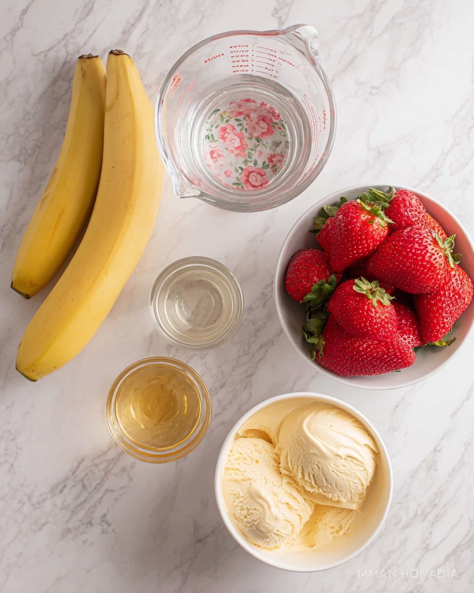 Two tall clear glasses filled with a creamy pink and light yellow smoothie that looks thick and frothy. The smoothie has swirls and layers of pale pink and light yellow colors blending together from top to bottom inside the glasses. Each glass is topped with a slice of bright red strawberry and a small green mint leaf on the creamy light yellow foam at the top. The glasses sit on a light bamboo mat with a white marbled background. Photo taken with an iphone --ar 4:5 --v 7