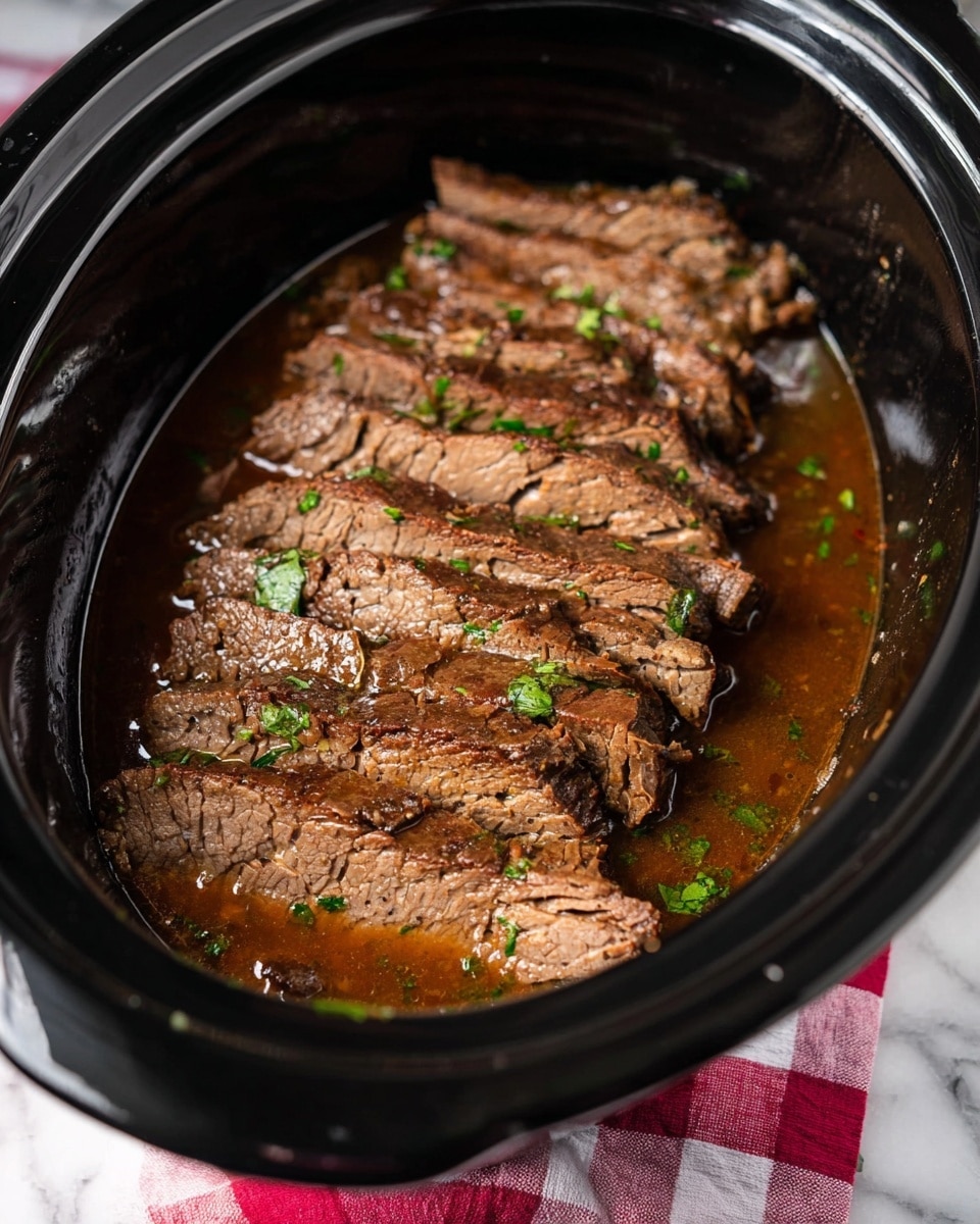 The image shows several slices of cooked beef placed side by side on an antique silver serving tray with ornate edges. The beef is medium brown with a slightly fibrous texture, and a few green herb pieces are sprinkled on top. The tray holds some dark brown meat juice that adds shine and moisture to the slices. A white marbled surface is beneath the tray, and a small part of a red and white checkered cloth is seen nearby. A woman's hand holding a fork is visible at the bottom right corner. photo taken with an iphone --ar 4:5 --v 7