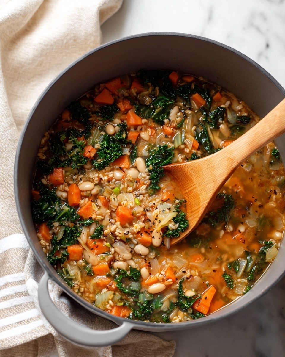 A big white pot filled halfway with cooked vegetables and grains sits on a white marbled surface. The mix inside shows pieces of orange carrots, green leafy kale, and small white beans, all mixed in with light brown grains. A wooden spoon rests inside, touching the food, and the pot has a curved rim with a wide handle visible on the left. The colors inside the pot are warm and natural, with a soft light shining on the food and the edge of the pot. photo taken with an iphone --ar 4:5 --v 7
