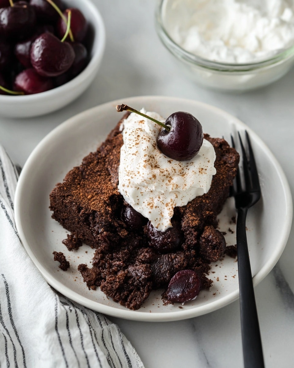 A white plate holds a dark brown chocolate cake with a rough texture and some crumbly pieces on the edges. On top of the cake is a dollop of white whipped cream sprinkled with light brown cinnamon powder. Next to the whipped cream is a dark red cherry with a shiny surface. Two black forks rest on the plate, partly covering the cake. Around the plate, on a white marbled surface, there is a bowl of dark red cherries and a glass bowl of white whipped cream. A white cloth with black stripes lies near the plate. photo taken with an iphone --ar 4:5 --v 7
