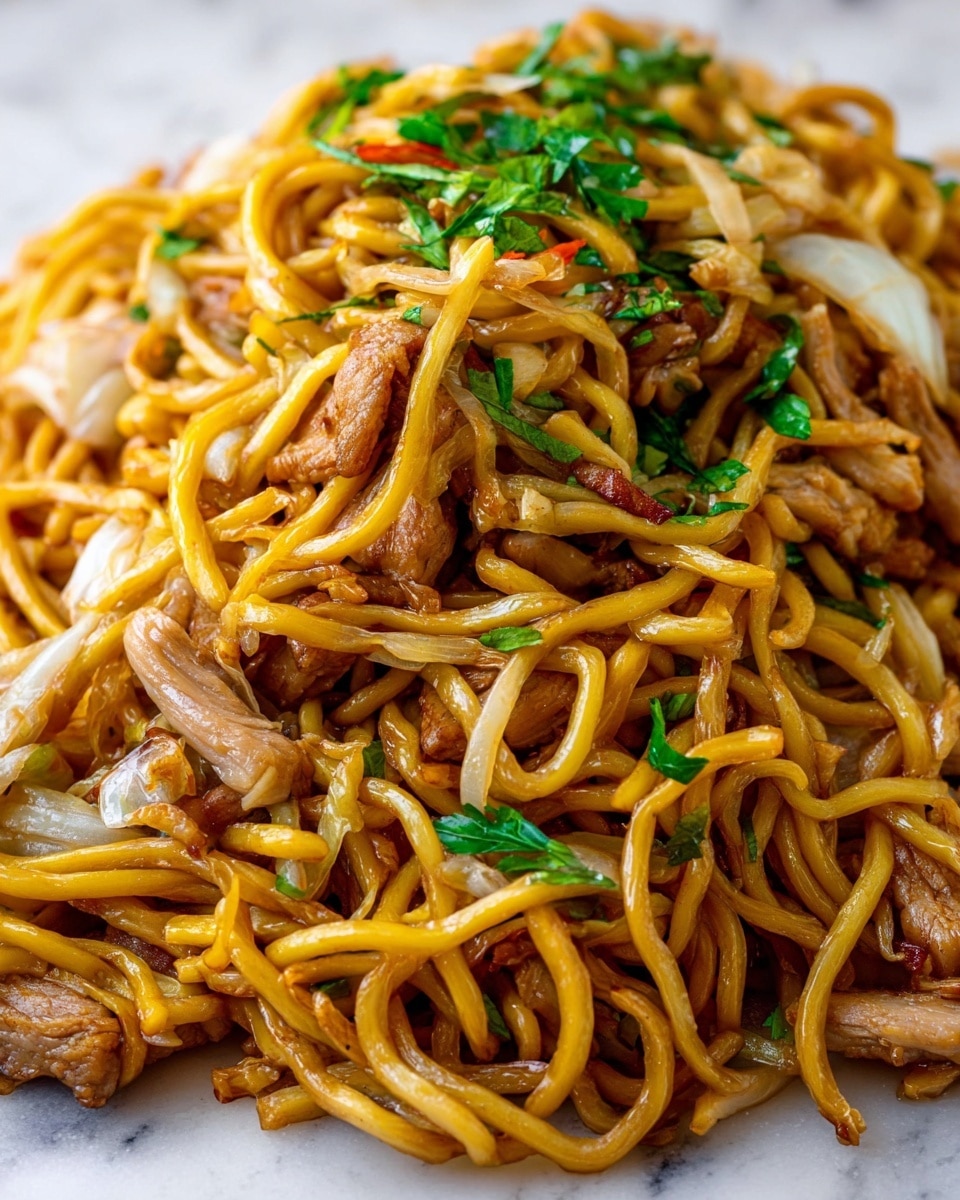 A close-up of a white plate filled with stir-fried noodles, slightly glossy light golden strands mixed with light brown pieces of cooked chicken and white cabbage slices. Some small bits of orange carrot and green onion slices are scattered throughout, adding spots of color on top and inside the noodle pile. A pair of wooden chopsticks rests on the top right edge of the plate. The background shows a white marbled surface. photo taken with an iphone --ar 4:5 --v 7