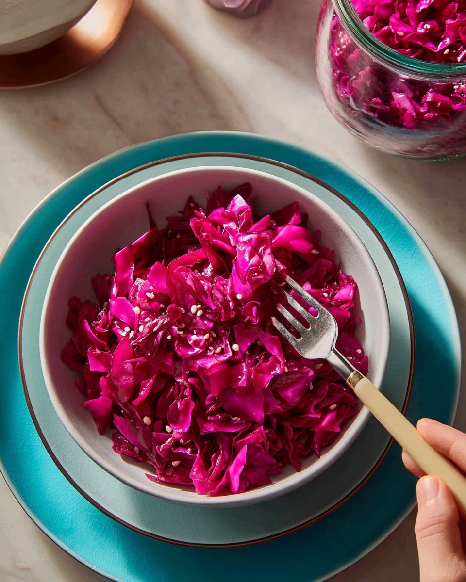A close-up of a metal colander filled with finely chopped purple cabbage. The cabbage pieces have a mix of deep purple and light violet shades with some white parts visible. A woman's hand holds the colander handle on the left side. The background is a white marbled surface. photo taken with an iphone --ar 4:5 --v 7