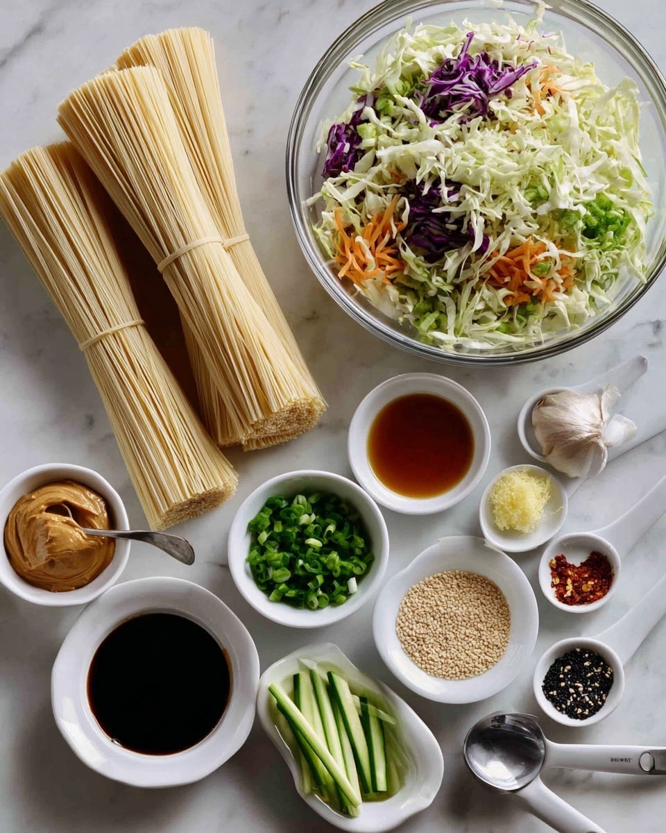 This image shows ingredients for a noodle dish on a white marbled surface. On the left, there are two bundles of uncooked light beige noodles. To the right, there is a large clear glass bowl filled with mixed shredded cabbage, including white, green, purple, and some orange carrot pieces. Below that, there is a small white bowl with green chopped scallions and a round silver bowl with long, thin light green cucumber sticks. Around these are various small white bowls and spoons holding sauces and ingredients: a light tan peanut butter spoon, a small bowl of sesame seeds, a small white bowl with a light brown liquid, another small white bowl with a darker liquid, a spoon with minced ginger and garlic, and a spoon with black and white pepper and salt. Everything is carefully placed in neat rows, showing clear colors and textures of each ingredient. Photo taken with an iphone --ar 4:5 --v 7