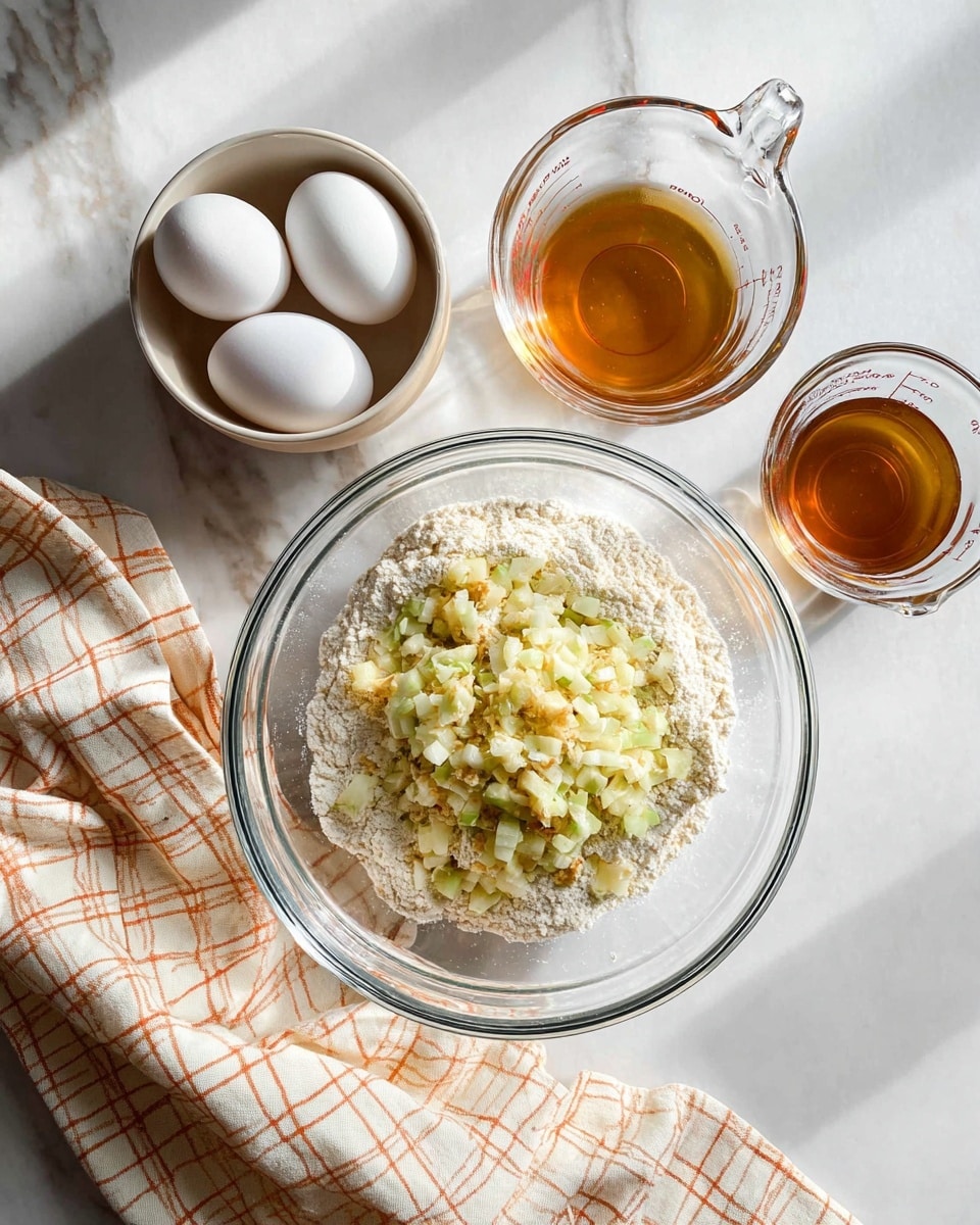 A clear glass bowl in the center contains a layer of white flour mixed with small, light greenish-yellow diced pieces of fruit or vegetable on top. To the upper left of this bowl, there is a smaller clear bowl holding two white eggs. Above the large bowl, two clear measuring cups are placed side by side on a white marbled surface, one filled with a light brown liquid and the other with a light amber liquid. A cream-colored cloth with a simple orange checkered pattern is draped along the bottom left corner of the scene. The overall setting is bright with natural light coming from above. photo taken with an iphone --ar 4:5 --v 7