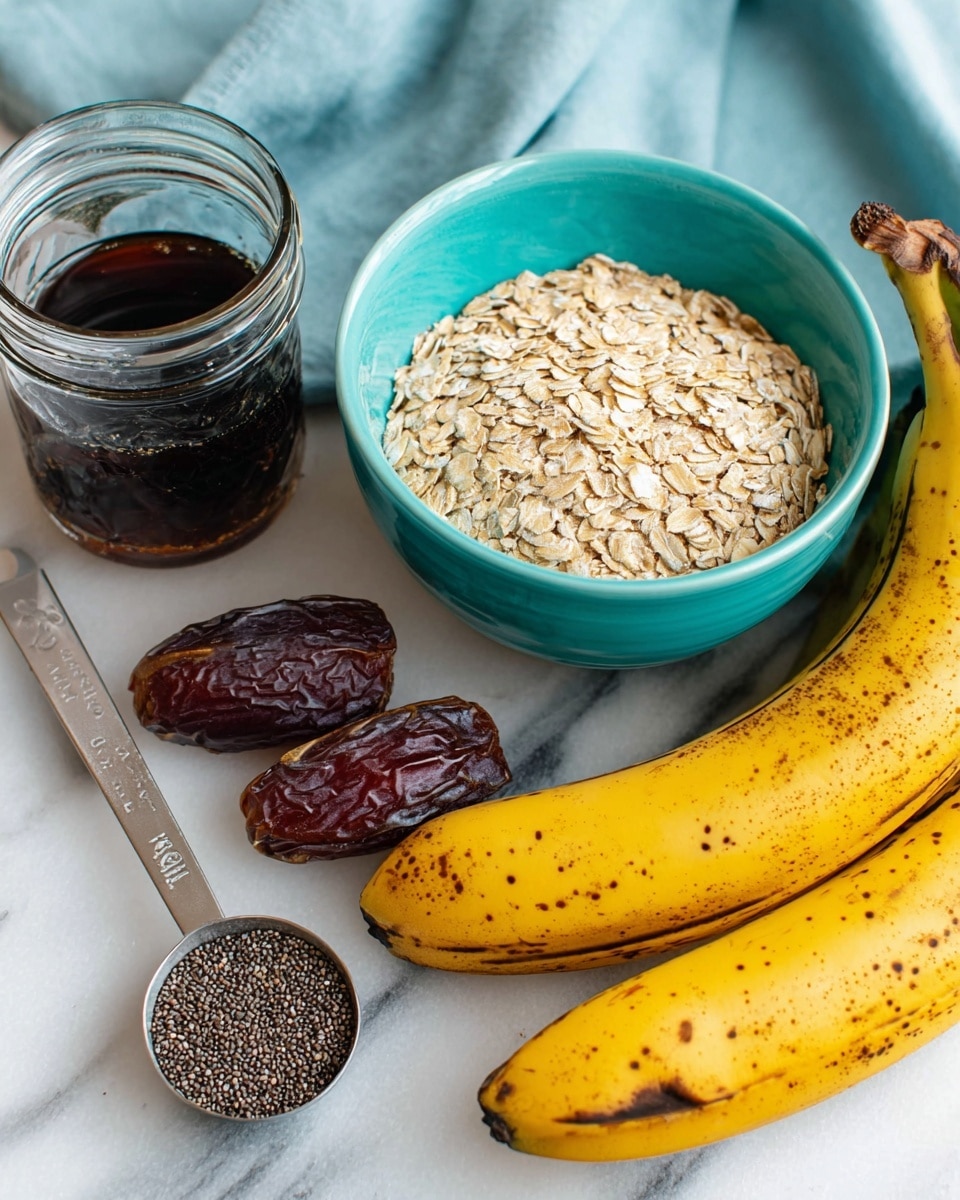 A bunch of ripe yellow bananas with brown spots lays near a turquoise bowl filled with dry light beige oats. Around them, there are a few dark brown dates, a clear glass jar filled with dark liquid, and a metal measuring spoon holding small black and white chia seeds. The items rest on a white marbled surface with a folded light blue cloth in the background. Photo taken with an iphone --ar 4:5 --v 7