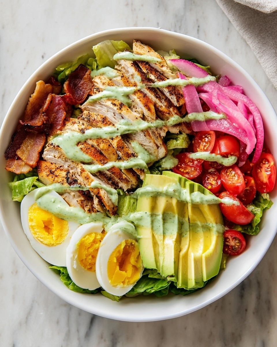 A white bowl holds a colorful salad with several distinct layers. The bottom layer is green lettuce, topped with strips of grilled chicken that have a light brown and slightly charred texture, drizzled with a green creamy dressing. To the left of the chicken are crispy, golden bacon pieces and thin, bright pink pickled onions. On the right side, there are evenly sliced hard-boiled eggs with bright yellow yolks, followed by fresh avocado slices that are bright green and smooth in texture. Cherry tomatoes, halved and red, are placed next to the avocado, also lightly drizzled with the green dressing. The bowl sits on a white marbled surface, and the photo has a clean, bright look. Photo taken with an iphone --ar 4:5 --v 7